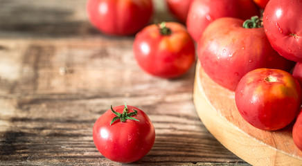 ripe Tomatoes on wooden background