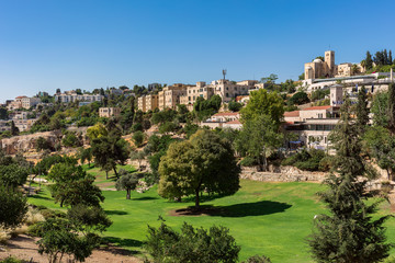 Green urban park and houses in Old Jerusalem.