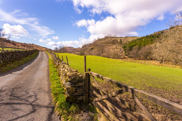 Fototapeta na wymiar Road through the countryside in The Lake District National Park, Cumbria, England