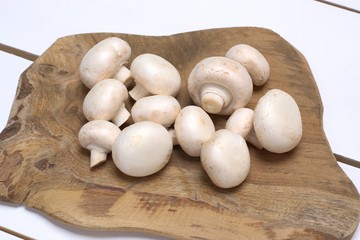 Fresh mushrooms on a white wooden table.