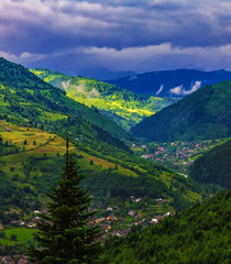 Fototapeta na wymiar Village located on the slope of a mountain ridge, nature background, panorama