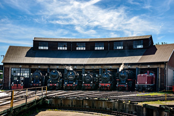 old retro steam engine train locomotives at the roundhouse