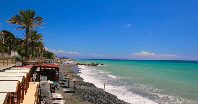 Coastline promenade with palm trees in Cogoleto town, Italian Riviera, Italy
