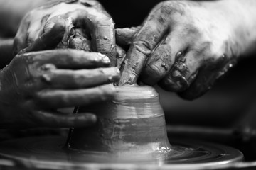 Potter making ceramic pot on the pottery wheel