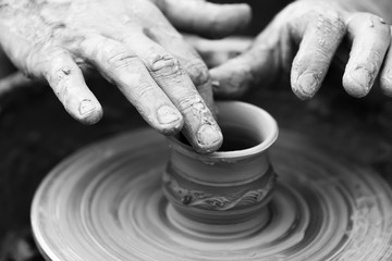 Potter making ceramic pot on the pottery wheel