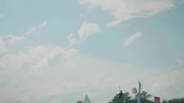 View of man riding zip line in mountains