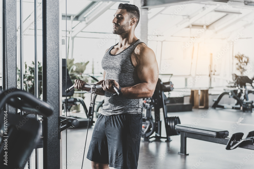 Wall mural smiling man working out with equipment