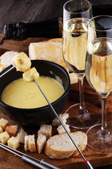 Gourmet Swiss fondue dinner on a winter evening with assorted ch