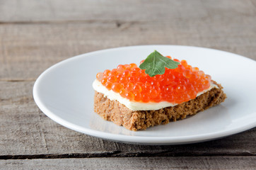 Sandwich salmon caviar white plate butter