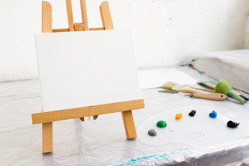 Creative art studio. Artistic tools. Painter workplace, hobby for children, blank canvas on easel