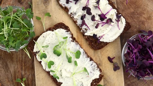 Fresh made Bread with Cream Cheese and Cress (rotating) as seamless loopable 4K UHD footage)