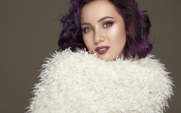 Portrait of beautiful sexy fashion model with purple hair over grey background