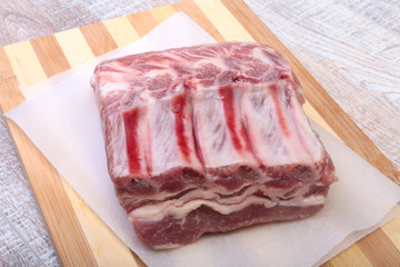 Raw pork chops, spices on cutting board. Ready for cooking.
