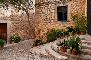 Old European street decorated with fresh flowers city of Valldemossa. Palma de Mallorca. Spain.
