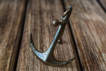 Anchor on a wooden background © OLEKSII