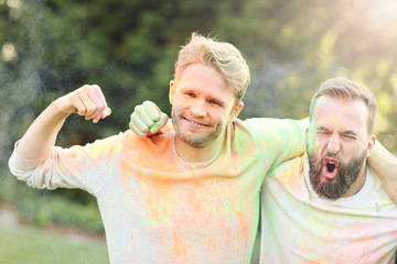 Group of friends having fun at color festival