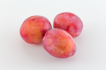 Fresh plums isolated on white background