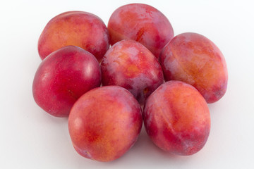 Fresh plums isolated on white background