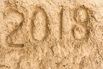 Inscription 2018 on the yellow sand