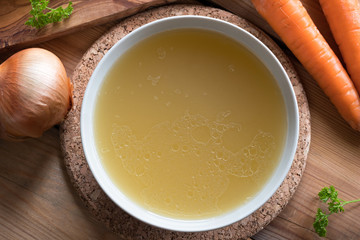 Bone broth made from chicken served in a plate