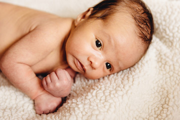 Newborn baby lying in a crib