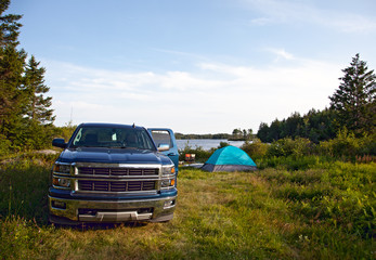 a pickup truck on a campsite - obrazy, fototapety, plakaty