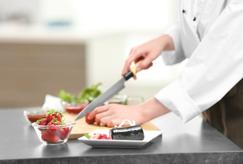 Obraz na płótnie Canvas Hands of female chef cooking in kitchen