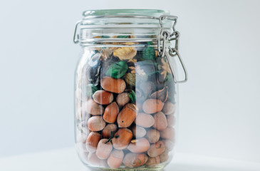 Plenty of hazelnut and other decorations in a jar