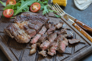 Grilled Steak on cutting board with green salad
