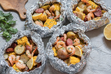 Fototapeta premium Homemade Traditional Cajun Shrimp Boil with Sausage Potato and Corn foil pack