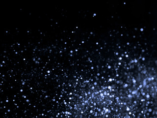 Silver overlay background of glittering lights with bokeh effect.