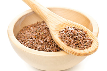 Raw, unprocessed linseed or flax seed in wooden bowl and wood spoon