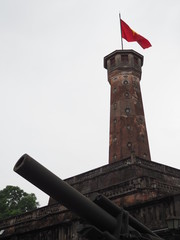 National treasure monument of Vietnam: Grand brick turret with cannon and Vietnam flag in Hanoi