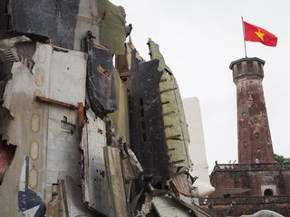 Grand brick turret of Hanoi with war plane crashed remain statue