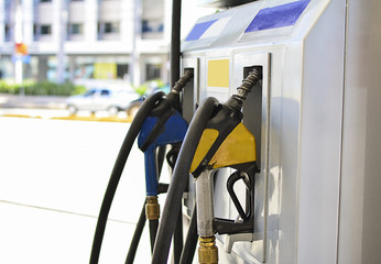 Closeup of a gas pump nozzles at gas station