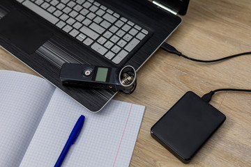 journalist's work at a computer with a voice recorder. 