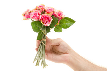 Small bouquet of flowers in male hands isolated