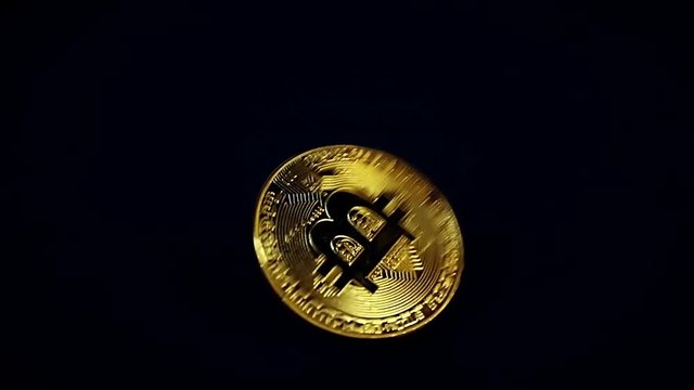 Crypto currency Gold Bitcoin - BTC - Bit Coin. Bitcoin slow motion rotation over black.