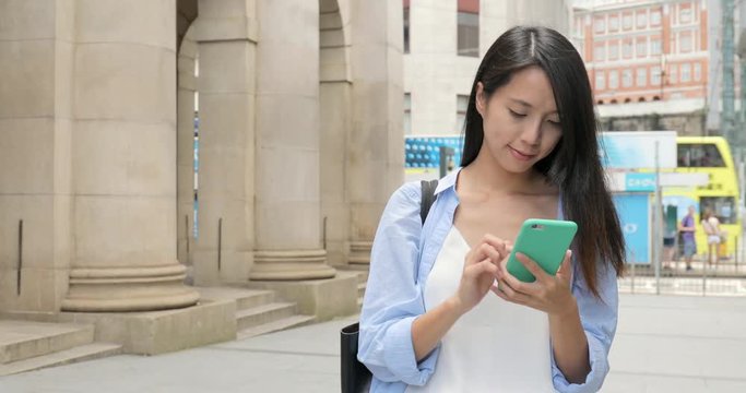 Woman working on cellphone at outdoor