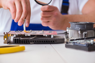 Computer repairman repairing desktop computer