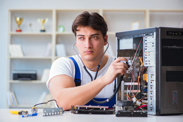Fototapeta na wymiar Computer repairman repairing desktop computer
