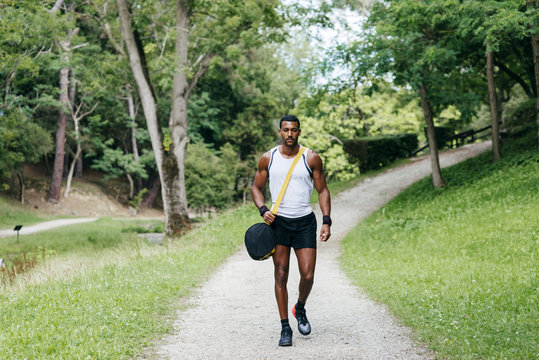 Muscular Young Man Walking In Park