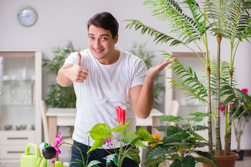Young man in gardening concept at home