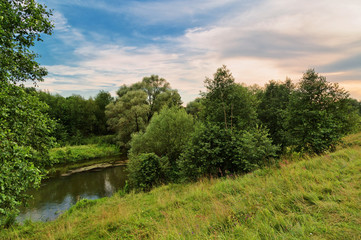 Fototapeta na wymiar small river in field