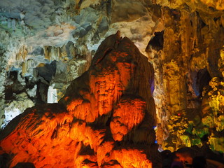 Stalactite rock with red light up decoration in the cave 