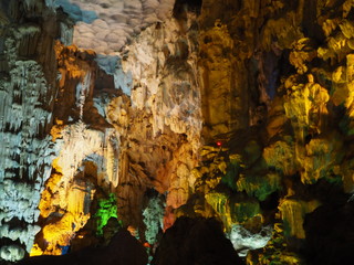 Grainy texture details of Stalactite in dark cave, with yellow and green light up decoration