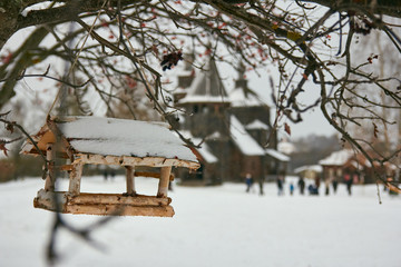 Birdhouse with old wooden Church at background
