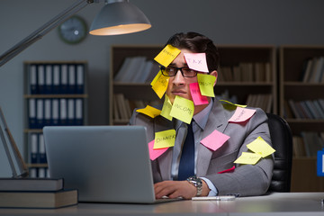 Businessman staying late to sort out priorities