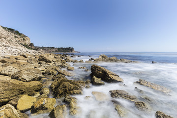 Fototapeta na wymiar Rocky Palos Verdes Estates coast with motion blur waves in Los Angeles County, California. 