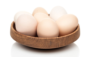 chicken eggs in a wooden plate isolated on white background